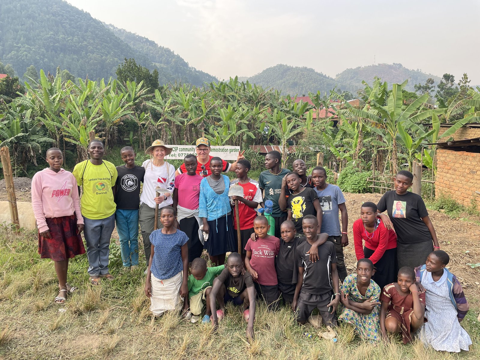 Group photo with children and visitors at the community garden in Buhoma near Bwindi, Uganda